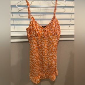 Orange short summer dress with white flowers